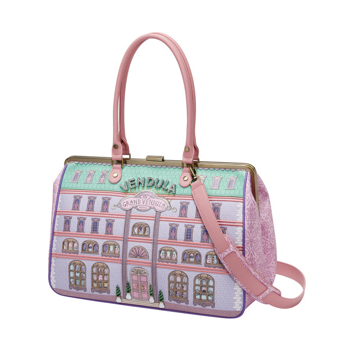 Handbag with a building design and pink strap on a white background