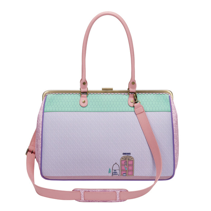 Handbag with pink strap and pastel color design on a white background