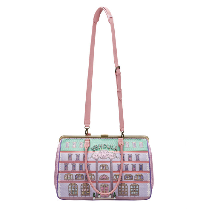 Handbag with architectural design and pink strap on a white background