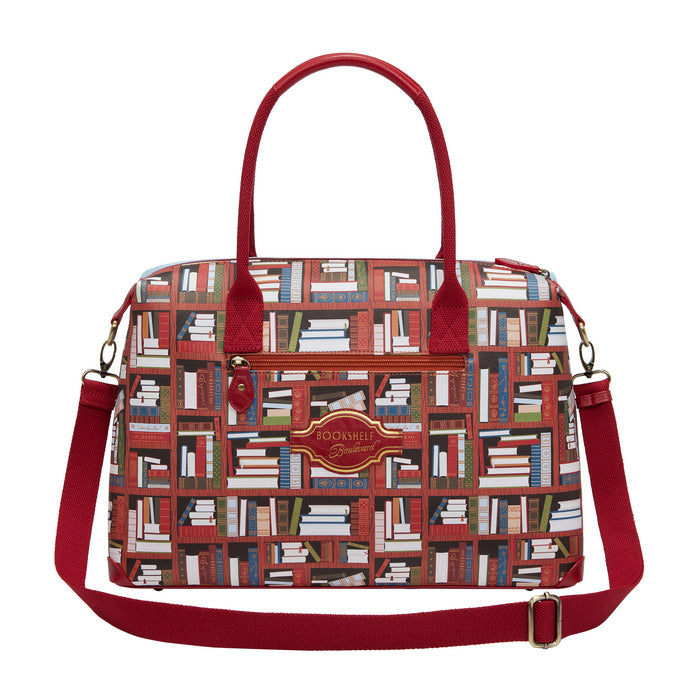 Handbag with book pattern and red handles and strap on a white background