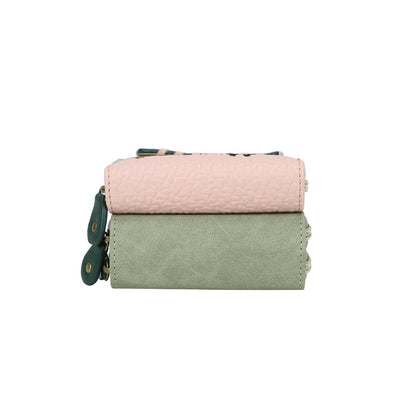 Two fabric bags, one pink and one green, stacked on a white background.