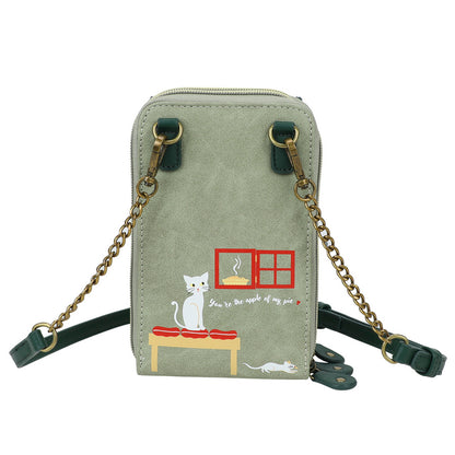 Green crossbody bag with cat illustration on a white background