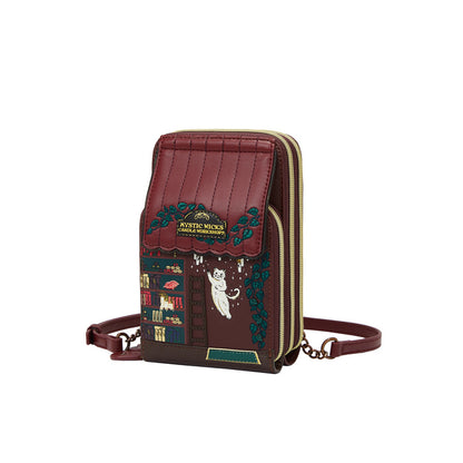 Brown crossbody bag with decorative elements on a white background