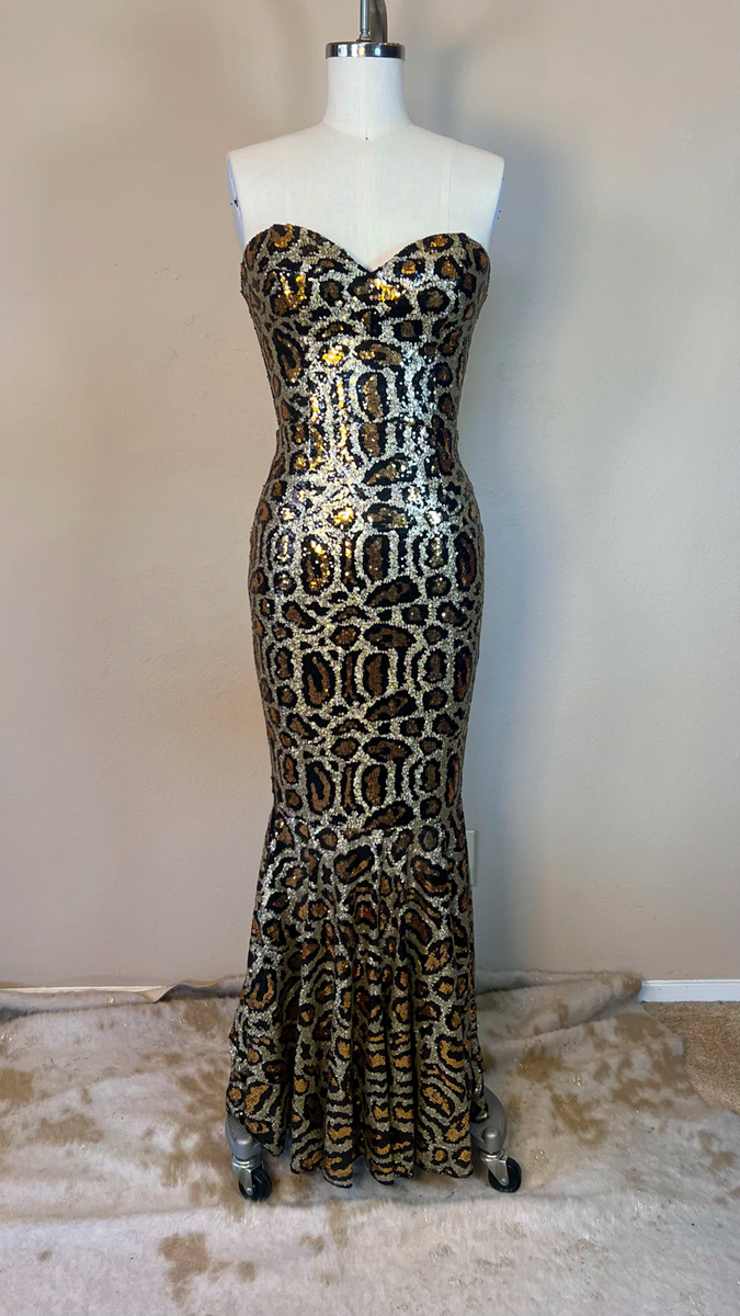 Leopard print strapless gown on a mannequin against a plain background