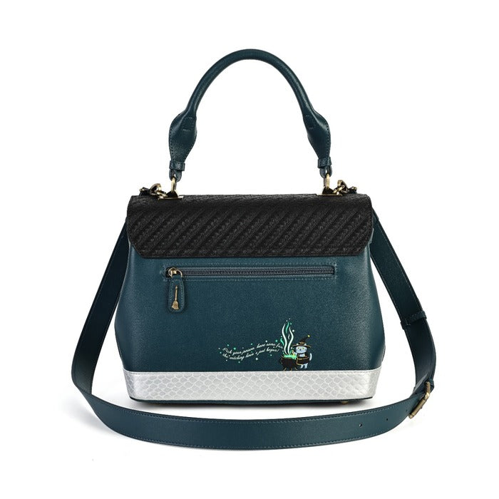 A dark teal handbag with a textured black top flap, a silver patterned base, and a matching shoulder strap, featuring a small embroidered design on the front.