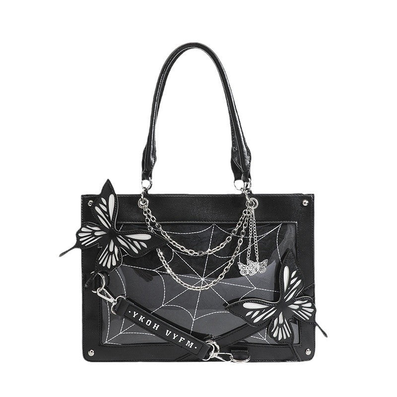 Black handbag with butterfly and spider web design on a white background