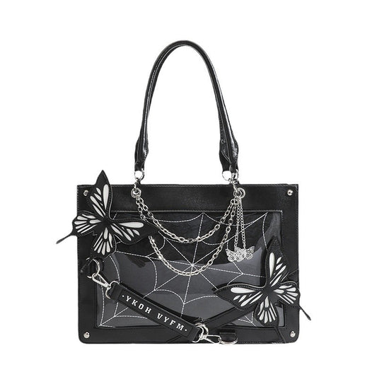 Black handbag with butterfly and spider web design on a white background
