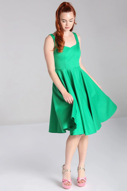 Woman wearing a green dress on a plain background