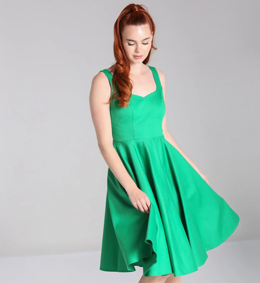 Woman wearing a green dress against a gray background