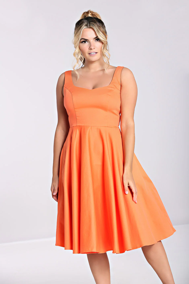 Woman wearing an orange dress against a white background
