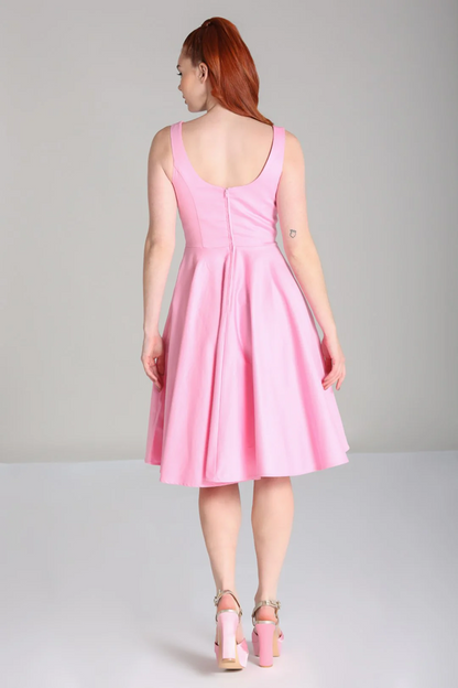 Woman wearing a pink dress on a gray background