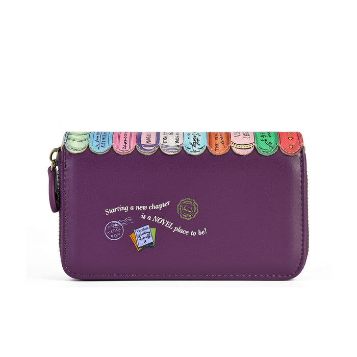 A purple zip-around wallet with a decorative top edge featuring colorful book spine designs and white script text on the front, shown on a plain white background.