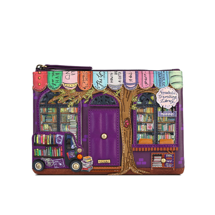 A purple zip-around clutch purse featuring a whimsical library storefront design with a purple door, bookshelves, a tree trunk, colorful book spines, and a small purple book truck, shown on a plain white background.