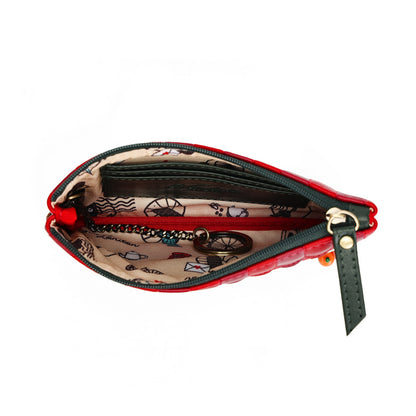 An open red quilted zip pouch wallet with a patterned beige interior and a dark green leather zipper pull, shown on a white background.