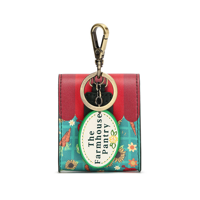 A small wallet keychain with a red and teal floral design, featuring a gold-tone clasp and a hanging oval tag that reads 'The Farmhouse Pantry'.