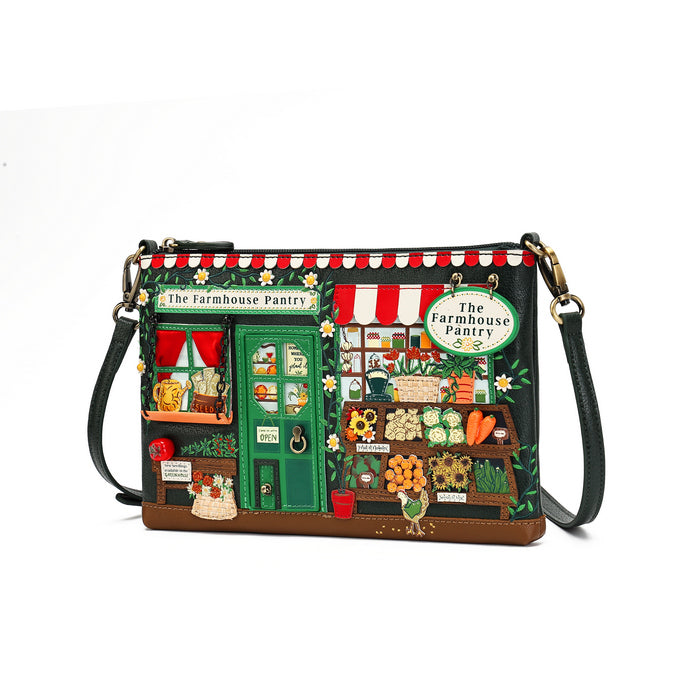 A rectangular shoulder bag with a whimsical embroidered 'The Farmhouse Pantry' storefront design, featuring a green door, red-and-white striped awning, and detailed market scene embroidery, shown on a white background.