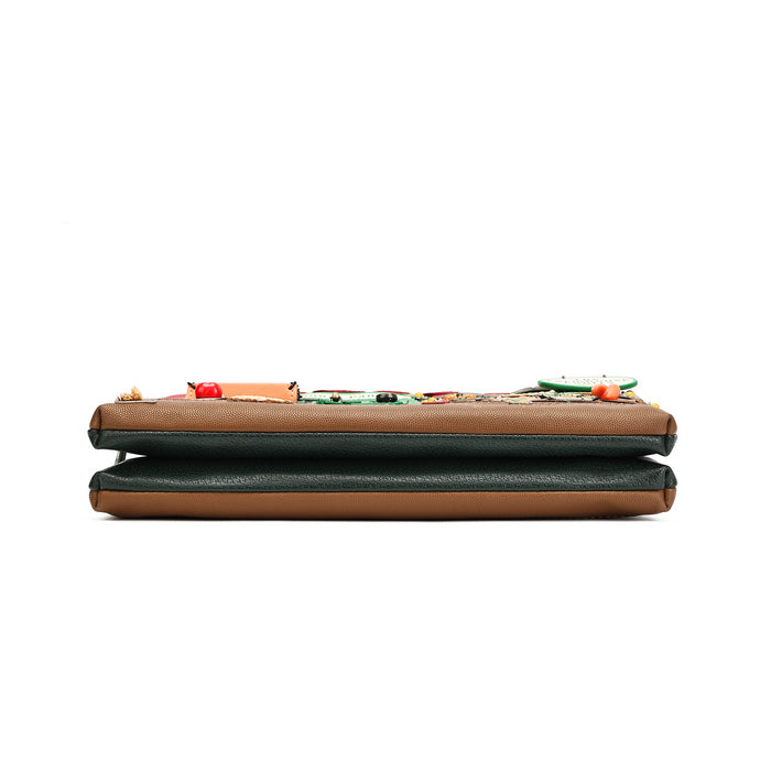 A folded leather clutch wallet with a tan leather base, dark green leather trim, and a colorful embroidered floral pattern across the top flap, shown on a plain white background.