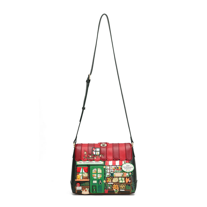 A red and green shoulder bag with a long black strap, featuring a detailed illustration of a market stall on the front.