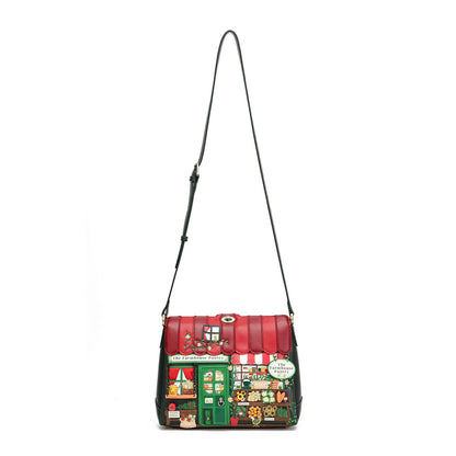 A red and green shoulder bag with a long black strap, featuring a detailed illustration of a market stall on the front.