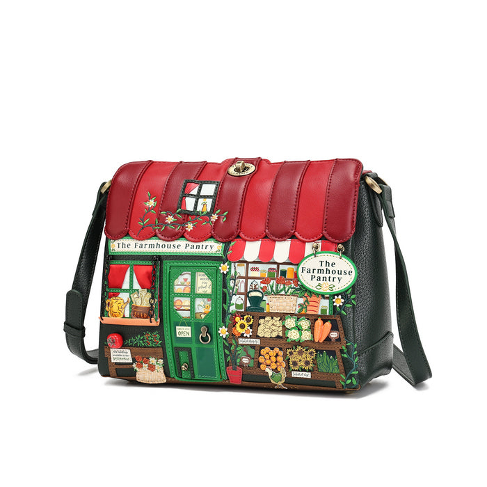 A shoulder bag designed to look like a colorful 'The Farmhouse Pantry' storefront, featuring a red faux-leather roof, a green door, and a detailed illustrated facade, shown on a plain white background.