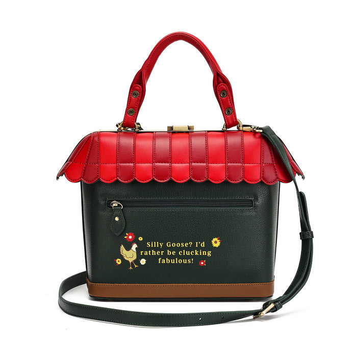 A structured handbag with a red roof and handles, a black body, and a brown base, featuring a decorative text print and a small rooster illustration on the front pocket.