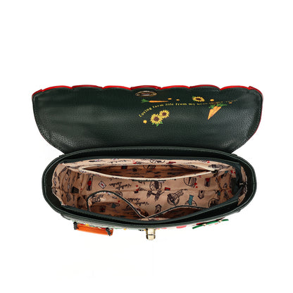 An open black pebbled leather clutch bag with a red trim, showing a patterned beige interior lining with vintage illustrations and a gold-tone clasp.