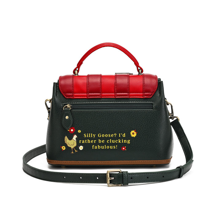 A black pebbled leather handbag with a bright red top handle and matching red quilted flap detail. The front features a black leather strap with gold-tone hardware and a humorous embroidered text design reading 'Silly Goose? I'd rather be stocking fabulous!' alongside a small chicken graphic.