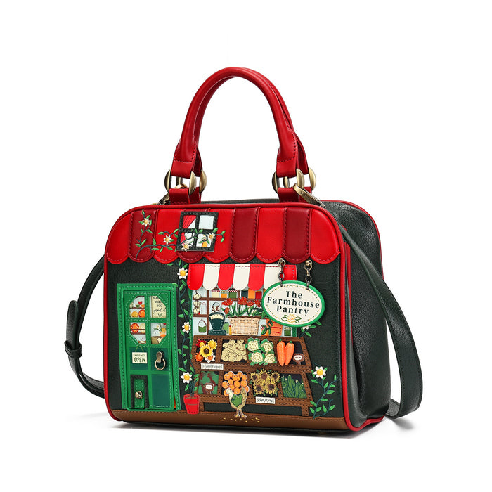 A structured handbag with a red top handle and black shoulder strap, featuring a colorful illustrated storefront design on the front with the text 'The Farmhouse Pantry' and small decorative details, shown on a plain white background.
