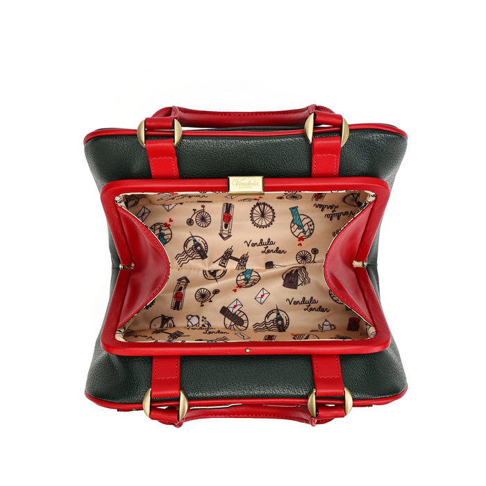 A structured handbag shown open from above on a white background, with dark green exterior, bright red trim and handles, gold-tone hardware, and a beige patterned interior lined with the brand name 'Victoria London'.