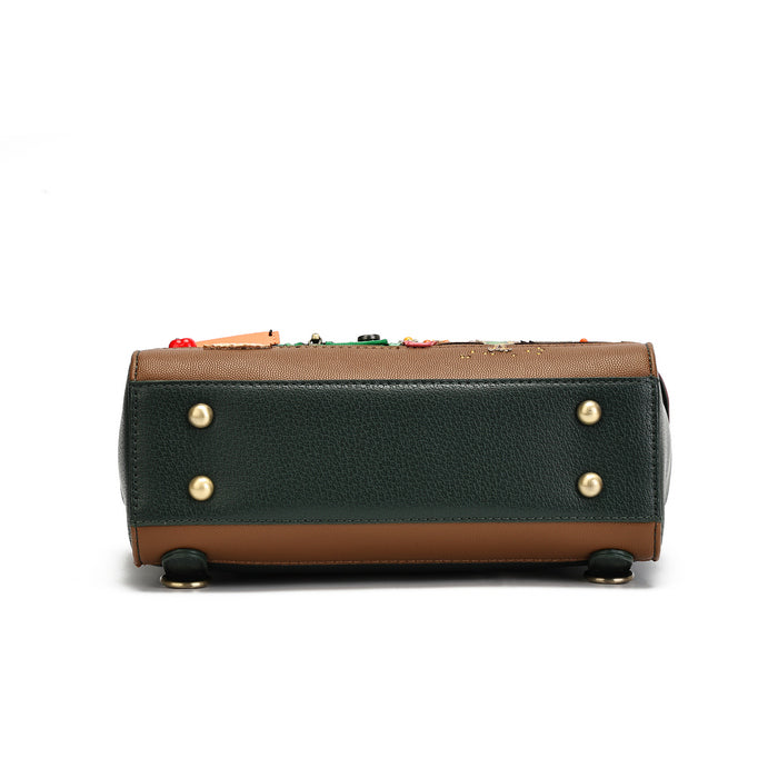 The bottom view of a structured handbag in dark green pebbled leather and brown leather, featuring gold-tone hardware and colorful decorative beads along the top edge, set against a plain white background.