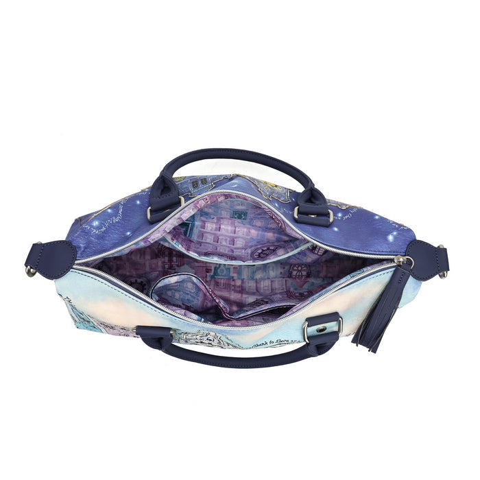 An open satchel handbag with a purple and blue galaxy cityscape print, featuring navy blue handles and trim, shown against a plain white background.