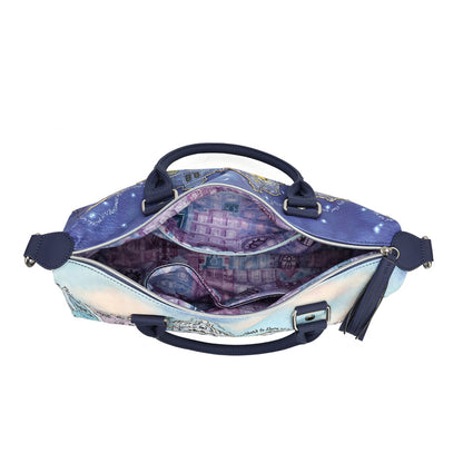 An open satchel handbag with a purple and blue galaxy cityscape print, featuring navy blue handles and trim, shown against a plain white background.