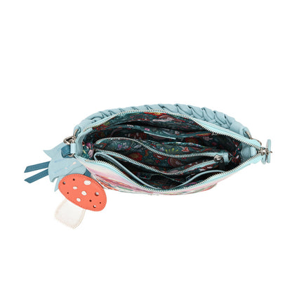 A practical crossbody with a top handle, detachable strap and a mix of internal and external pockets for everyday organisation. Printed and embossed vegan leather is finished with snowy toadstool houses, fairy doors, winter trees, rabbits and snowflakes.
