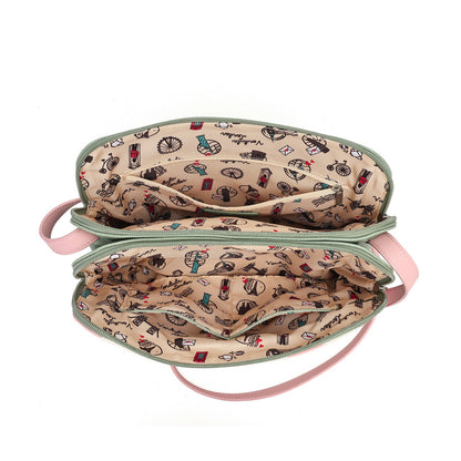 An open cosmetic bag with a beige interior printed with small colorful makeup and beauty-themed illustrations, a light pink exterior, and a matching pink strap, shown on a plain white background.