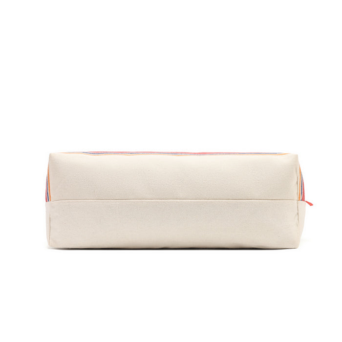 A rectangular canvas pouch in a warm cream or off-white color, featuring a thin multicolor stripe pattern along the top edge and a small red zipper pull, shown against a plain white background.