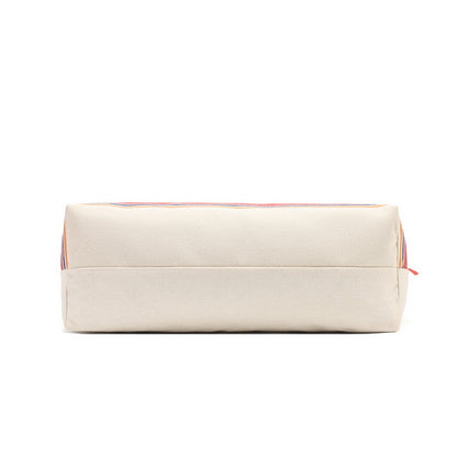 A rectangular canvas pouch in a warm cream or off-white color, featuring a thin multicolor stripe pattern along the top edge and a small red zipper pull, shown against a plain white background.