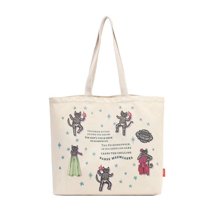 An off-white canvas tote bag featuring printed illustrations of skeleton cats in various poses, accompanied by text references to 'The Chronicles of Narnia' and small blue star accents, shown against a plain white background.