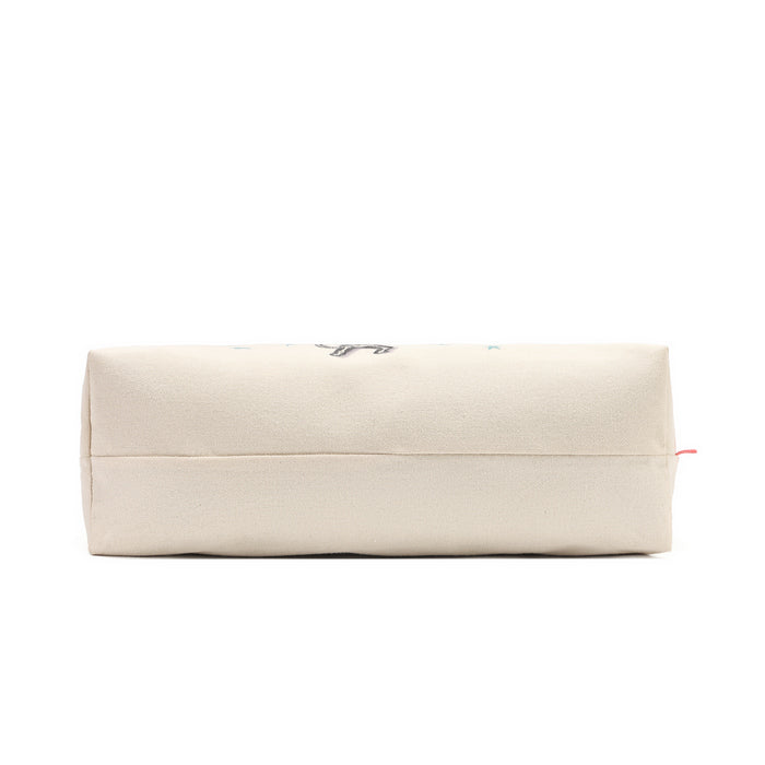 A cream-colored canvas zippered pouch with a small black graphic and a tiny red tag on the right side, shown against a plain white background.