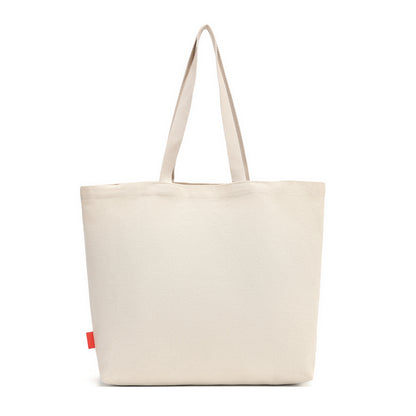 A lightweight recycled-canvas tote with a digital print featuring snowy toadstool houses, fairy doors, winter trees, rabbits and snowflakes. The roomy format is suited to shopping, errands or carrying extra everyday items.