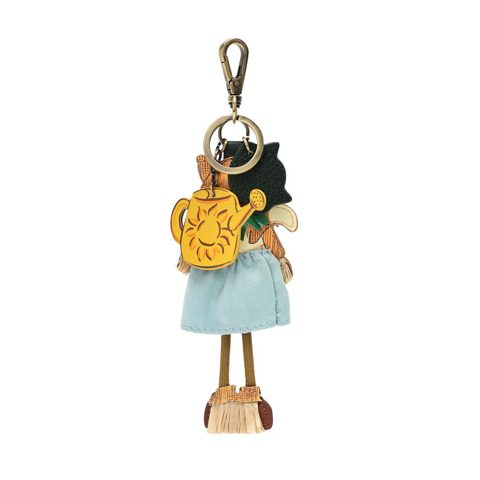 A small decorative keychain charm shaped like a stylized character holding a yellow watering can, shown on a plain white background.