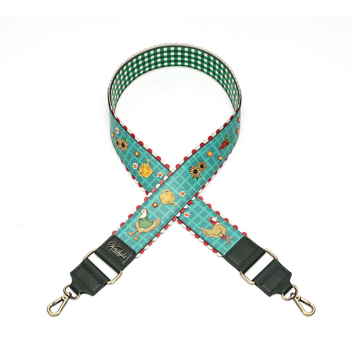 A fabric shoulder strap with a green and white gingham checkered inner lining, a teal patterned outer fabric featuring ducks, flowers, and red scalloped edges, finished with dark green leather ends and gold-tone swivel clips.