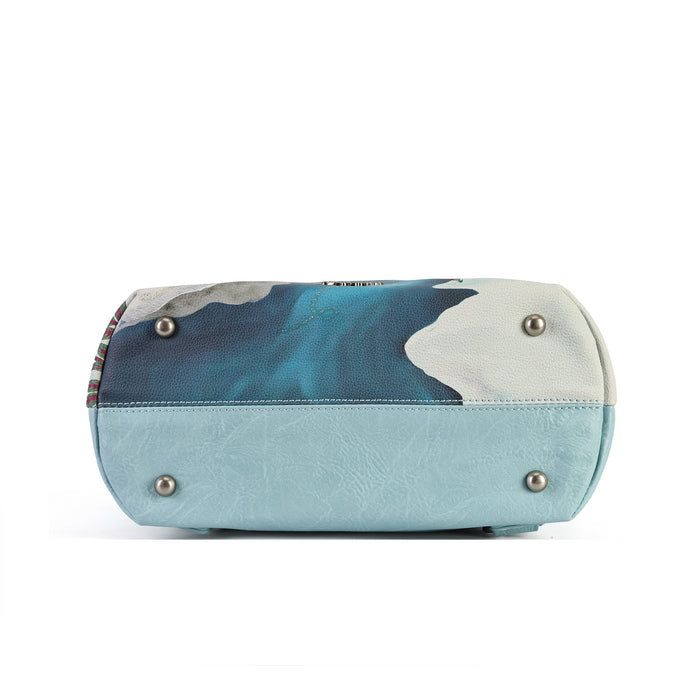 A versatile carryall that can be worn as a backpack, shoulder bag, crossbody or grab tote, with a padded tech section and organised internal storage. Embroidery and appliqué add texture to artwork featuring snowy toadstool houses, fairy doors, winter trees, rabbits and snowflakes.