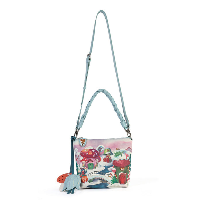 A practical crossbody with a top handle, detachable strap and a mix of internal and external pockets for everyday organisation. Printed and embossed vegan leather is finished with snowy toadstool houses, fairy doors, winter trees, rabbits and snowflakes.
