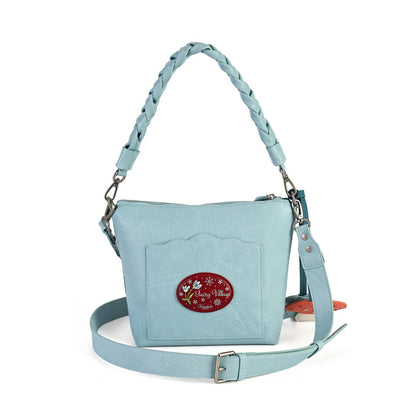 A practical crossbody with a top handle, detachable strap and a mix of internal and external pockets for everyday organisation. Printed and embossed vegan leather is finished with snowy toadstool houses, fairy doors, winter trees, rabbits and snowflakes.
