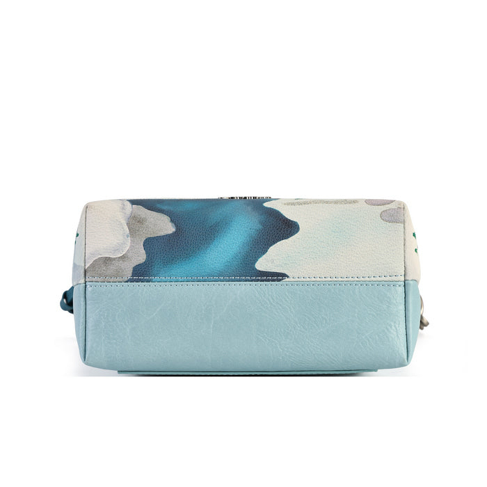 A practical crossbody with a top handle, detachable strap and a mix of internal and external pockets for everyday organisation. Printed and embossed vegan leather is finished with snowy toadstool houses, fairy doors, winter trees, rabbits and snowflakes.
