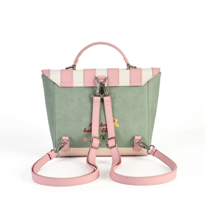 A pastel green and pink backpack with a top handle, shoulder straps, and a flap closure featuring pink and cream stripes. The front has pink adjustable shoulder straps with silver buckles, a pink top handle, and small embroidered details on a clean white background.