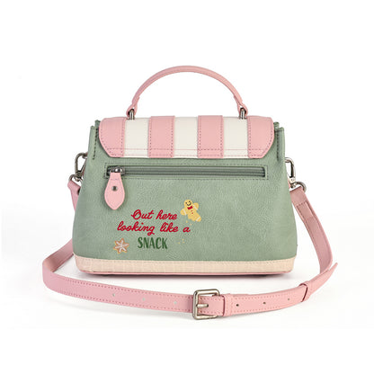 A pastel green and pink handbag with a top handle, a detachable pink shoulder strap, and embroidered text reading 'But here looking like a SNACK' with a small cartoon character on the front.