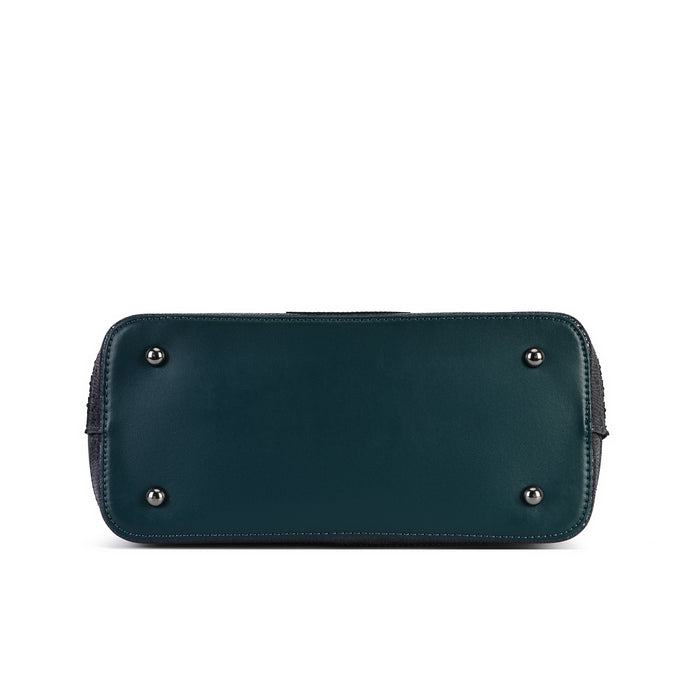 A dark teal leather clutch or wallet shown from the bottom, featuring four silver metal studs on the front, photographed against a solid white background.