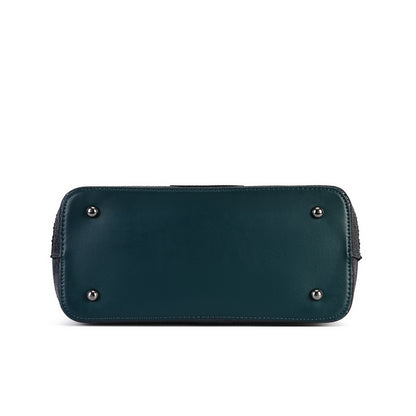 A dark teal leather clutch or wallet shown from the bottom, featuring four silver metal studs on the front, photographed against a solid white background.