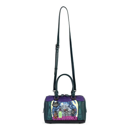 A structured handbag with a purple top panel, dark teal leather sides and shoulder strap, and a colorful illustrated front panel depicting a fantasy scene with a character on a pink carpet.